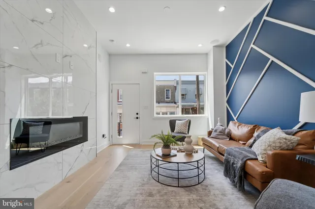 a living room with furniture kitchen and a fireplace