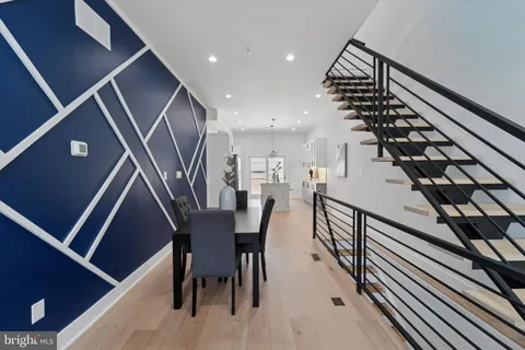 a dining room with furniture and wooden floor