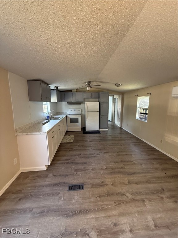 1277 Derby Lane Moore Haven, FL 33471 - Photo 2 of 7 a kitchen with stainless steel appliances granite countertop a sink and cabinets