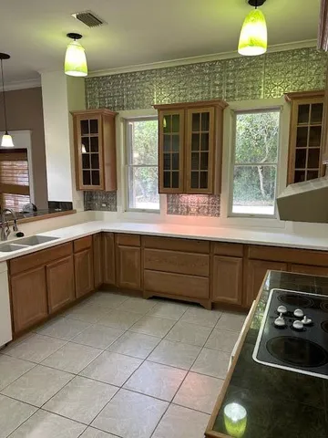 a kitchen with a sink stove and cabinets