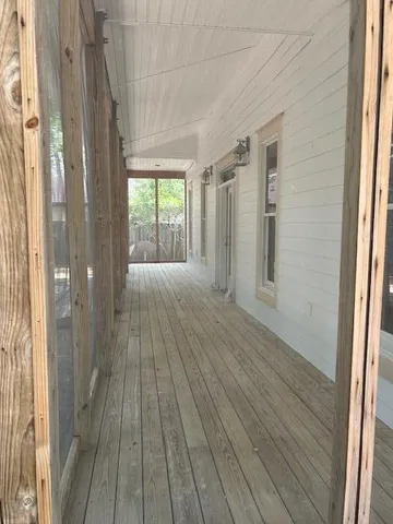 a view of a room with wooden floor and windows