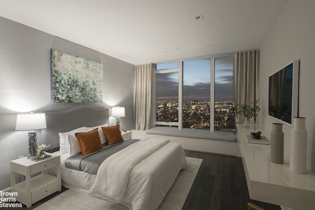 45 East 22nd Street, Unit 42A Manhattan, NY 10010 - Photo 15 of 23 a bedroom with a large bed and a flat tv screen on the dresser