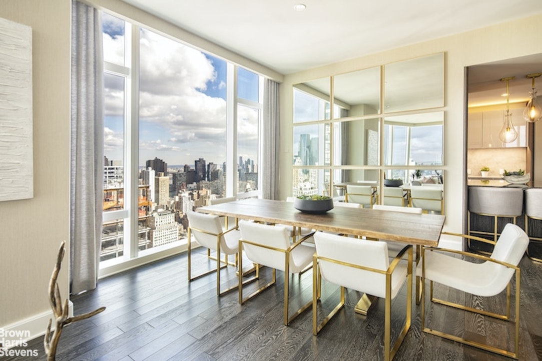 45 East 22nd Street, Unit 42A Manhattan, NY 10010 - Photo 6 of 23 a dining room with furniture large windows and wooden floor