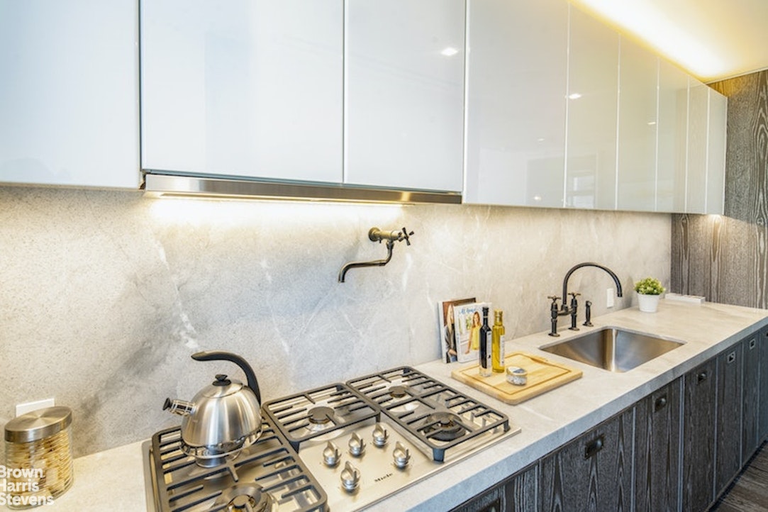 45 East 22nd Street, Unit 42A Manhattan, NY 10010 - Photo 7 of 23 a kitchen with a sink and cabinets