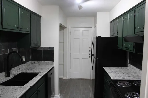 a kitchen with a refrigerator and a sink