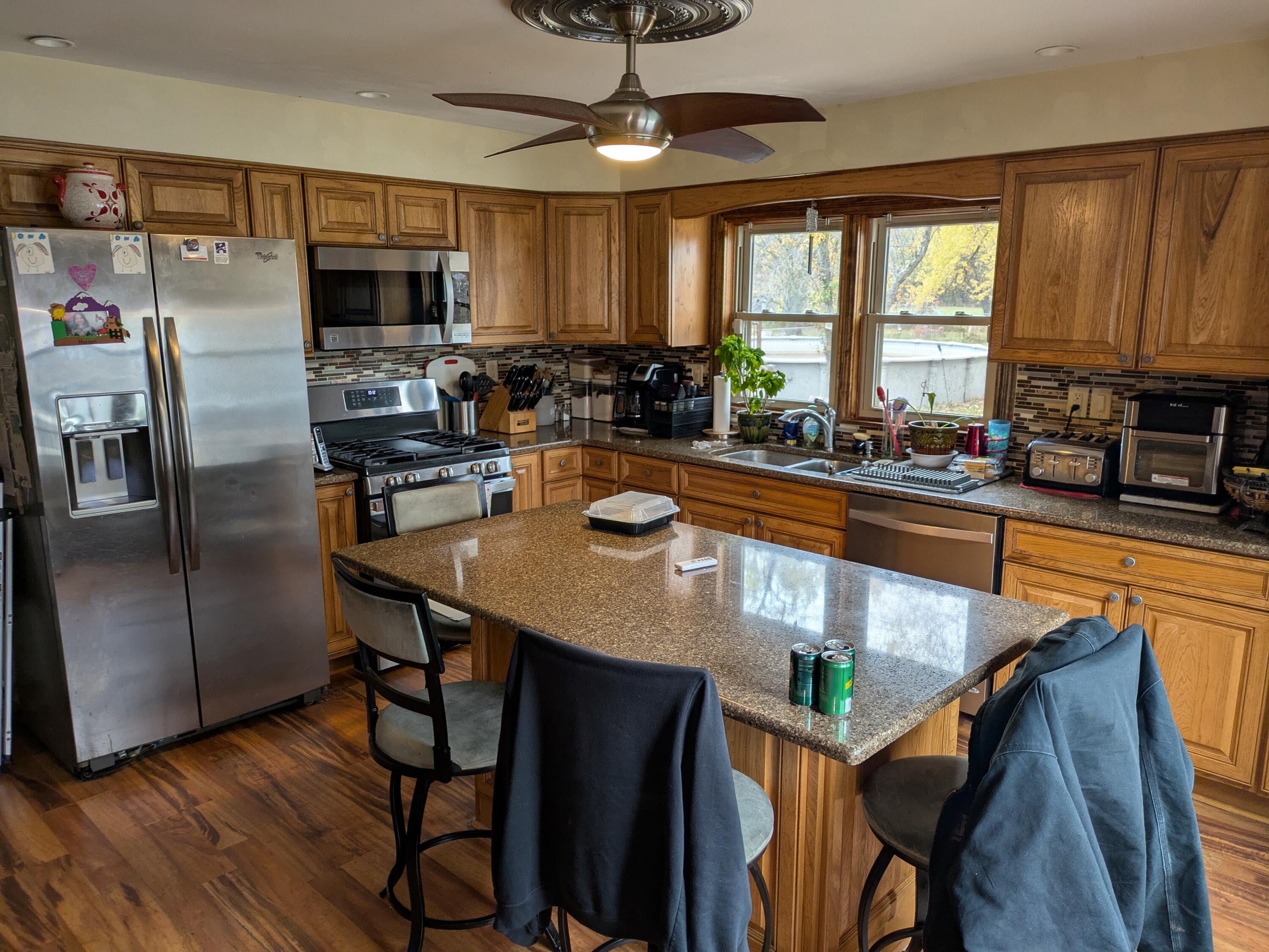 315 North Hobart Road Hobart, IN 46342 - Photo 5 of 33 a kitchen with stainless steel appliances granite countertop a sink a stove a refrigerator cabinets and a dining table