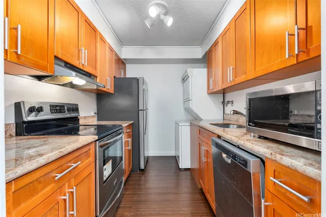 a kitchen with stainless steel appliances granite countertop a stove refrigerator and a microwave