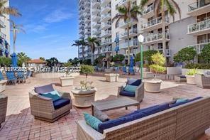 5077 Northwest 7th Street, Unit 1402 Miami, FL 33126 - Photo 21 of 87 a view of a patio with couches and potted plants