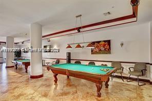 5077 Northwest 7th Street, Unit 1402 Miami, FL 33126 - Photo 3 of 87 a room with lots of furniture and air hockey table