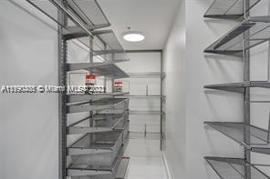 5077 Northwest 7th Street, Unit 1402 Miami, FL 33126 - Photo 60 of 87 a view of store room with racks