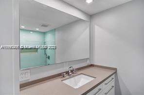 5077 Northwest 7th Street, Unit 1402 Miami, FL 33126 - Photo 62 of 87 a bathroom with a sink vanity and a mirror