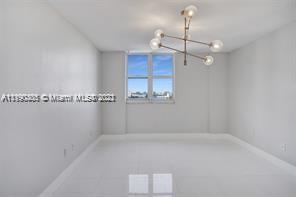 5077 Northwest 7th Street, Unit 1402 Miami, FL 33126 - Photo 68 of 87 a view of a room with a ceiling fan and a window