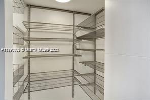 5077 Northwest 7th Street, Unit 1402 Miami, FL 33126 - Photo 75 of 87 a view of a room with racks on the wall