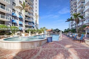 5077 Northwest 7th Street, Unit 1402 Miami, FL 33126 - Photo 10 of 87 a view of a swimming pool with outdoor seating
