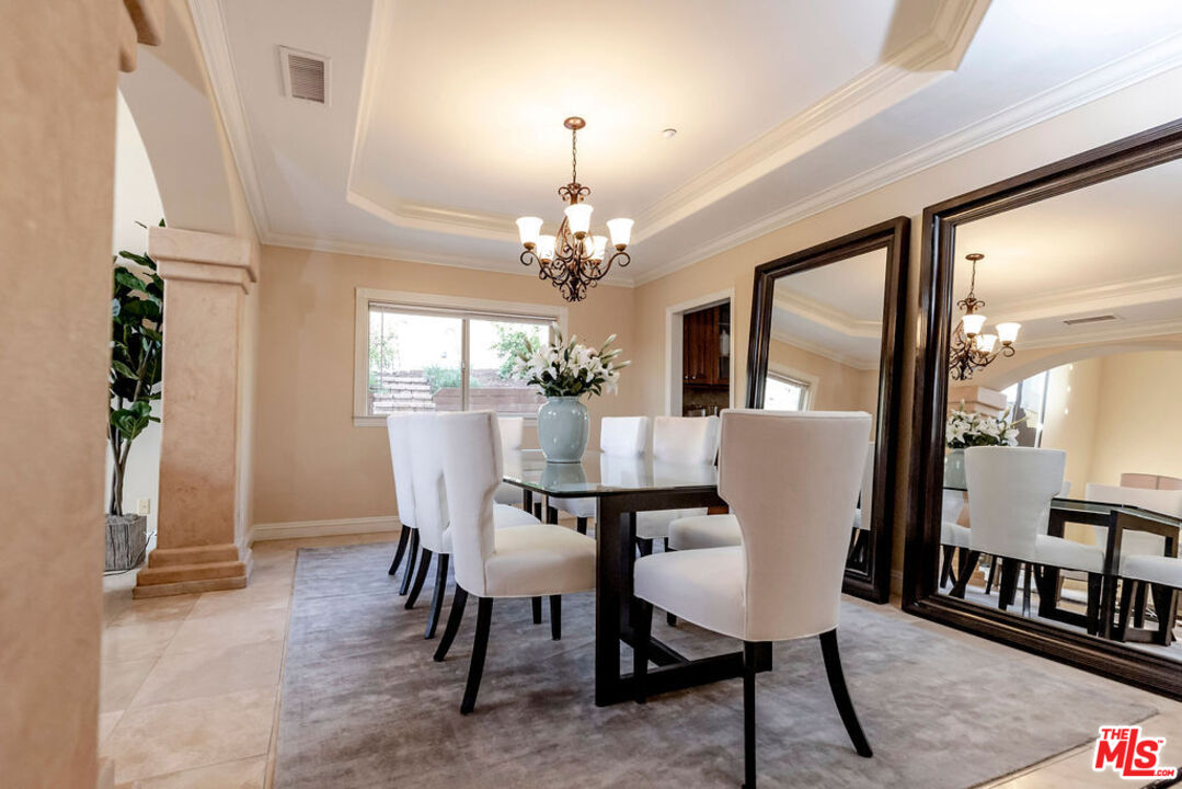 7634 Rocky Mountain View Road Tujunga, CA 91042 - Photo 12 of 50 a view of a dining room with furniture and a chandelier