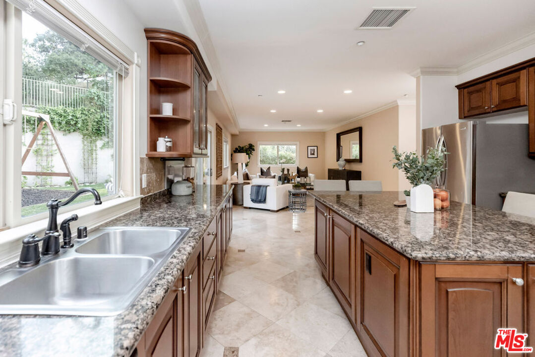7634 Rocky Mountain View Road Tujunga, CA 91042 - Photo 18 of 50 a kitchen with sink a counter top space and living room