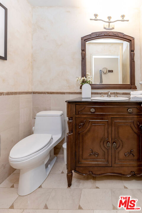 7634 Rocky Mountain View Road Tujunga, CA 91042 - Photo 23 of 50 a bathroom with a toilet a sink and mirror