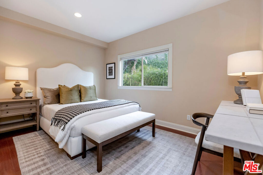 7634 Rocky Mountain View Road Tujunga, CA 91042 - Photo 25 of 50 a spacious bedroom with a bed and a lamp on table