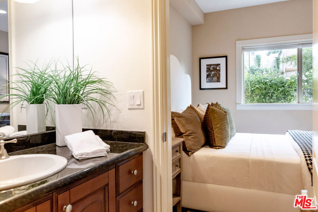 7634 Rocky Mountain View Road Tujunga, CA 91042 - Photo 27 of 50 a bedroom with a bed and a potted plant