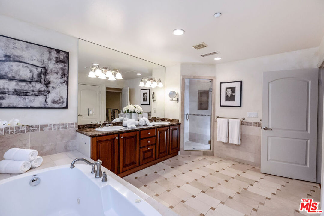 7634 Rocky Mountain View Road Tujunga, CA 91042 - Photo 38 of 50 a large bathroom with a sink a bathtub a mirror and a shower