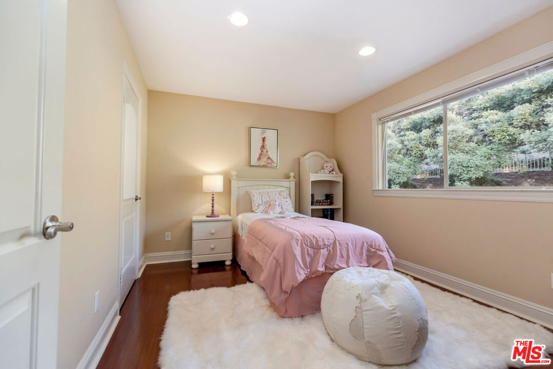 7634 Rocky Mountain View Road Tujunga, CA 91042 - Photo 42 of 50 a bedroom with a bed and a large window