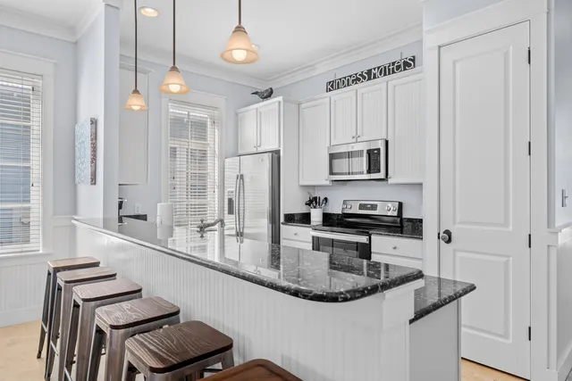 a kitchen with stainless steel appliances granite countertop a sink and a refrigerator