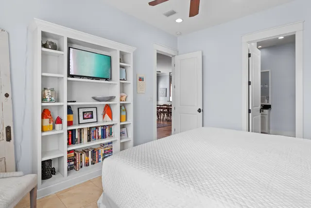 a bedroom with furniture and a book shelf