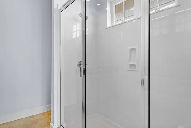 a bathroom with a glass shower door
