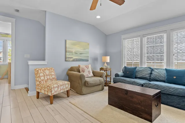 a living room with furniture and a floor to ceiling window