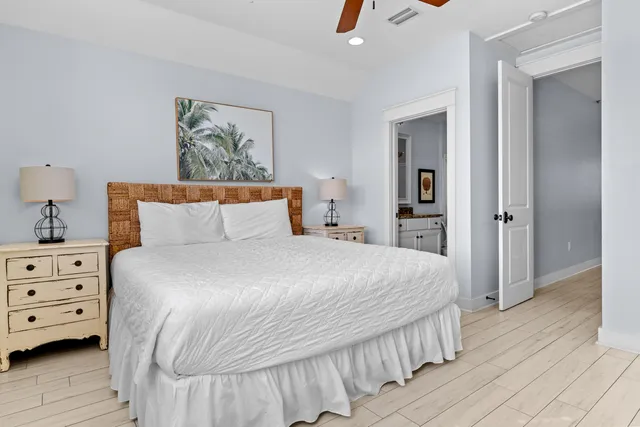 a bedroom with a bed and painting on the wall