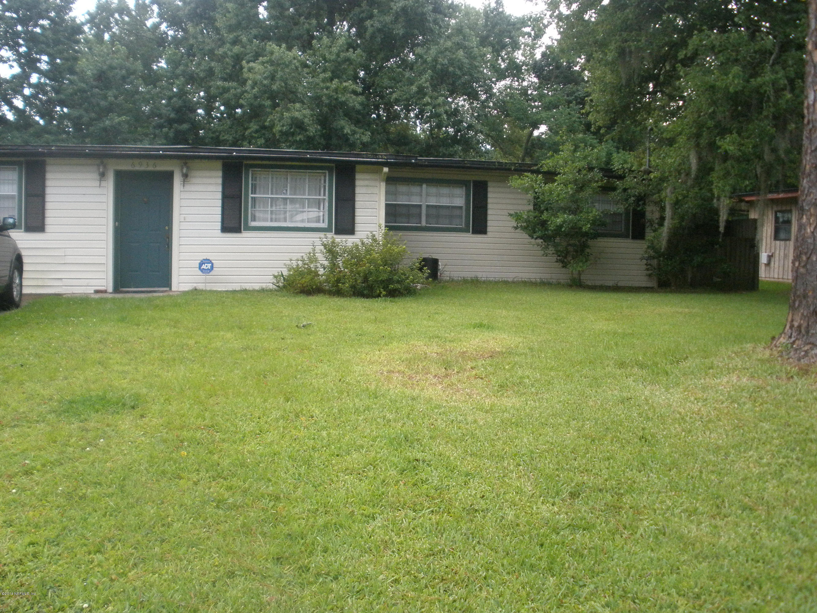 6936 Clovis Road Jacksonville, FL 32205 - Photo 1 of 4 a front view of house with yard and trees