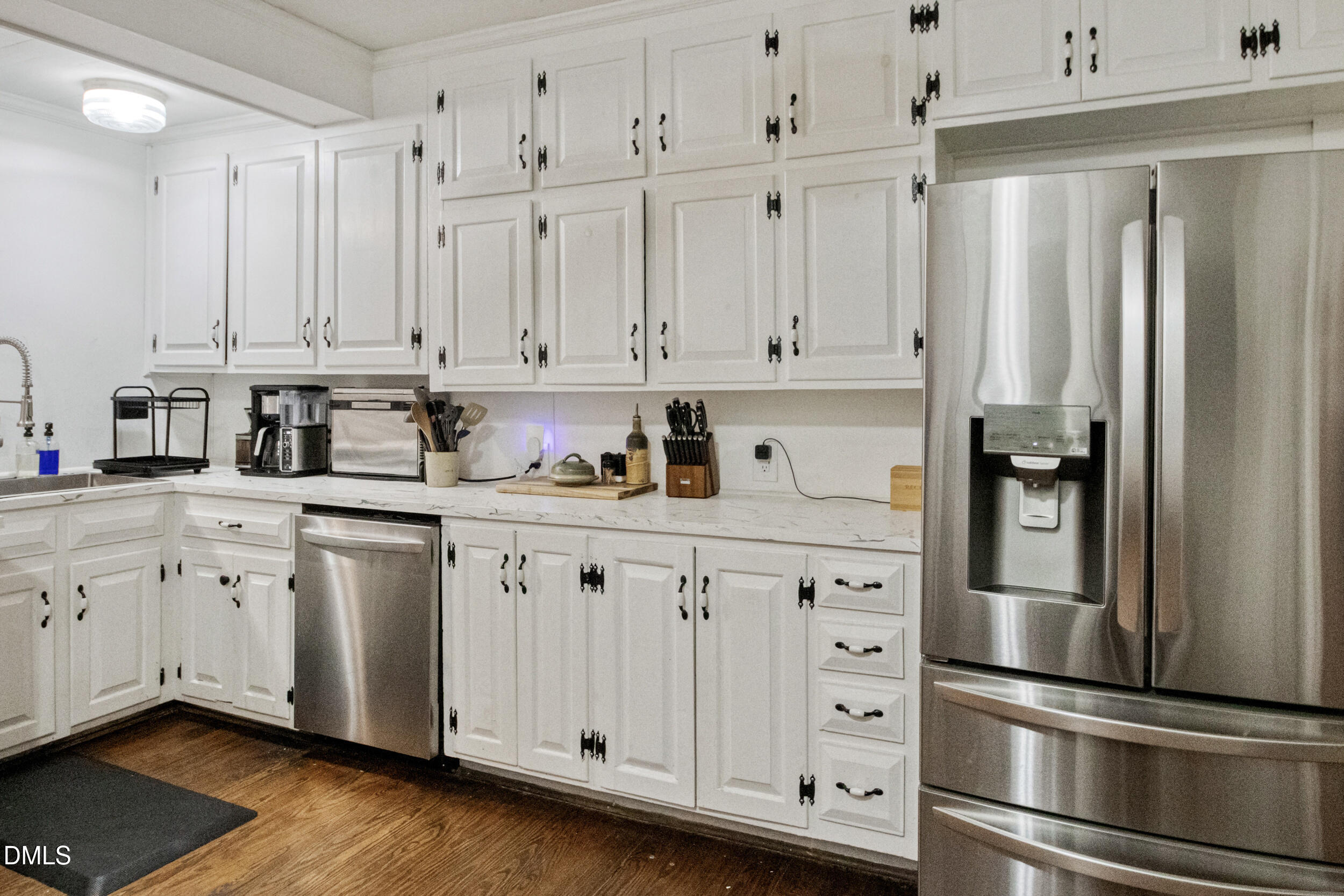 1734 Rocky Ford Road Henderson, NC 27537 - Photo 11 of 44 a kitchen with stainless steel appliances granite countertop a refrigerator and white cabinets