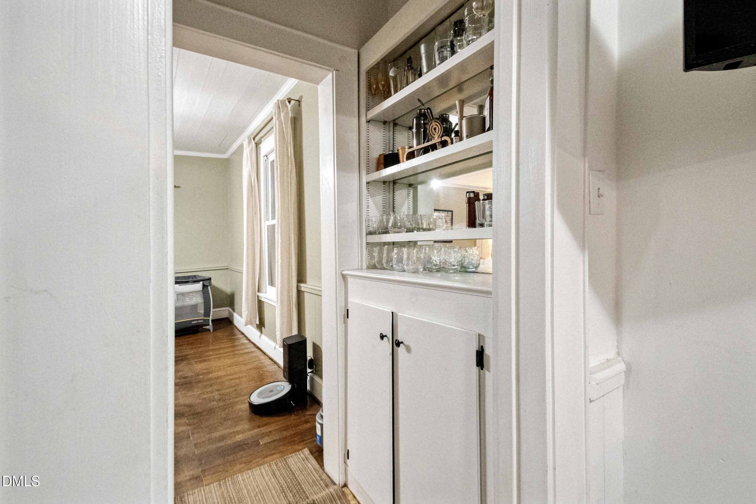 1734 Rocky Ford Road Henderson, NC 27537 - Photo 13 of 44 a hallway with white cabinets and wooden floor