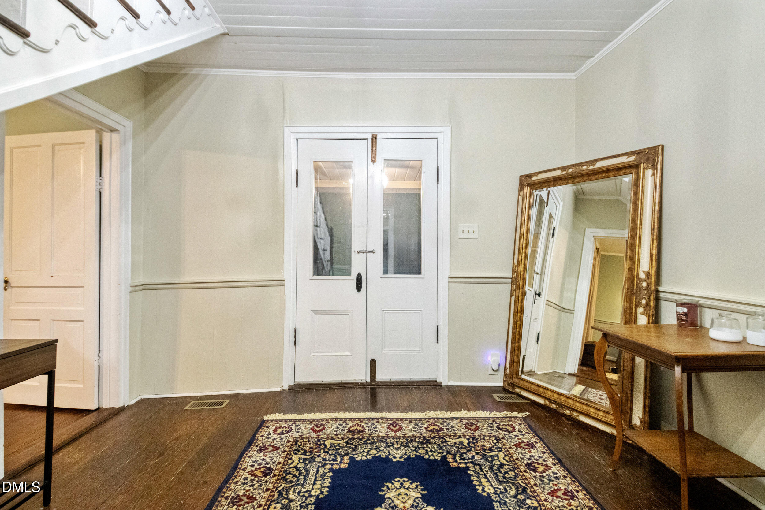 1734 Rocky Ford Road Henderson, NC 27537 - Photo 16 of 44 a view of a hallway with wooden floor and a living room