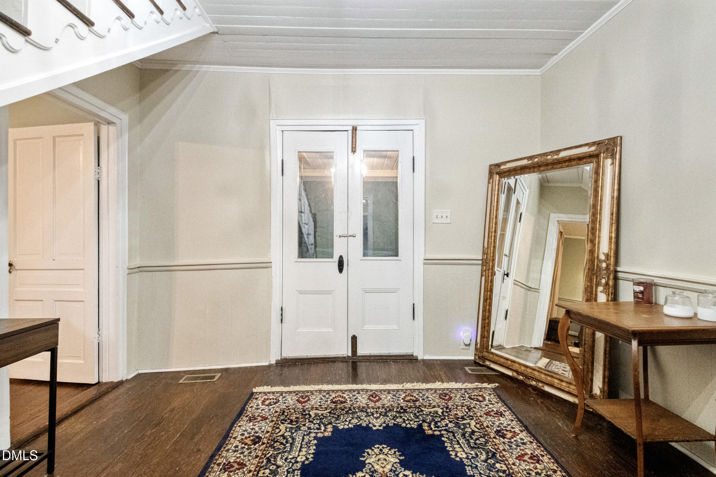 1734 Rocky Ford Road Henderson, NC 27537 - Photo 17 of 44 a view of a hallway with wooden floor and a living room