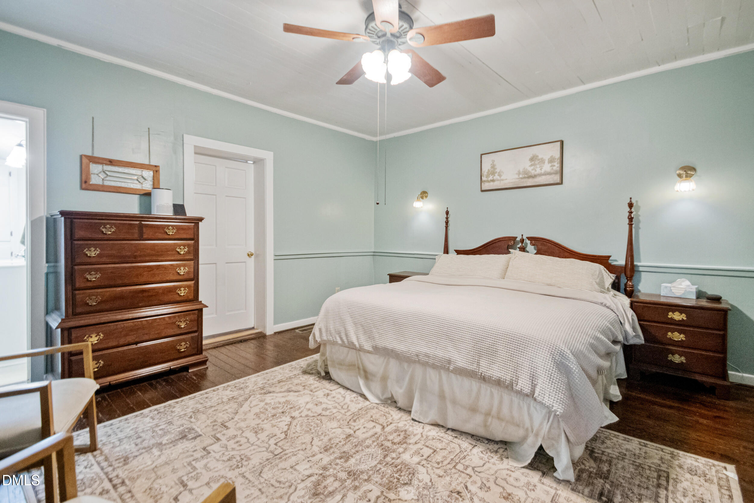 1734 Rocky Ford Road Henderson, NC 27537 - Photo 20 of 44 a bedroom with a bed and a chandelier