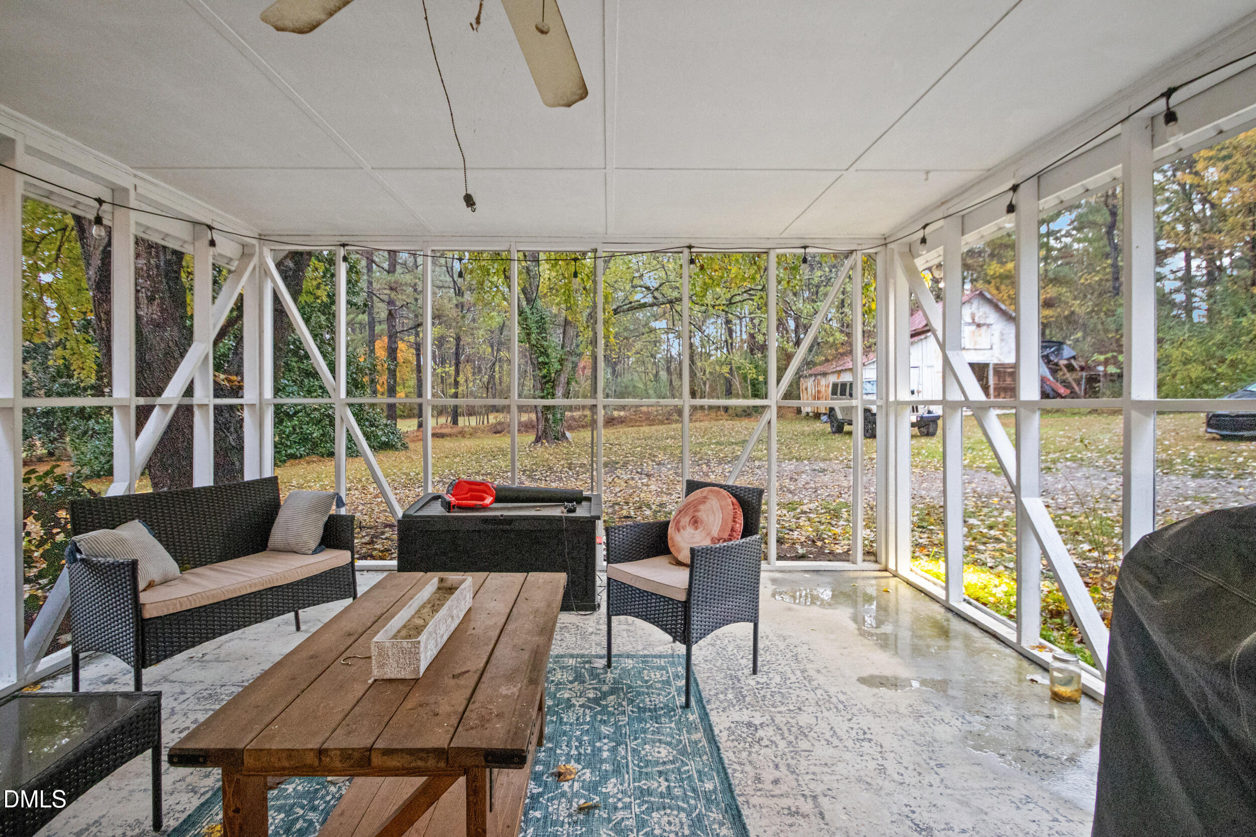 1734 Rocky Ford Road Henderson, NC 27537 - Photo 29 of 44 a living room with furniture and a floor to ceiling window