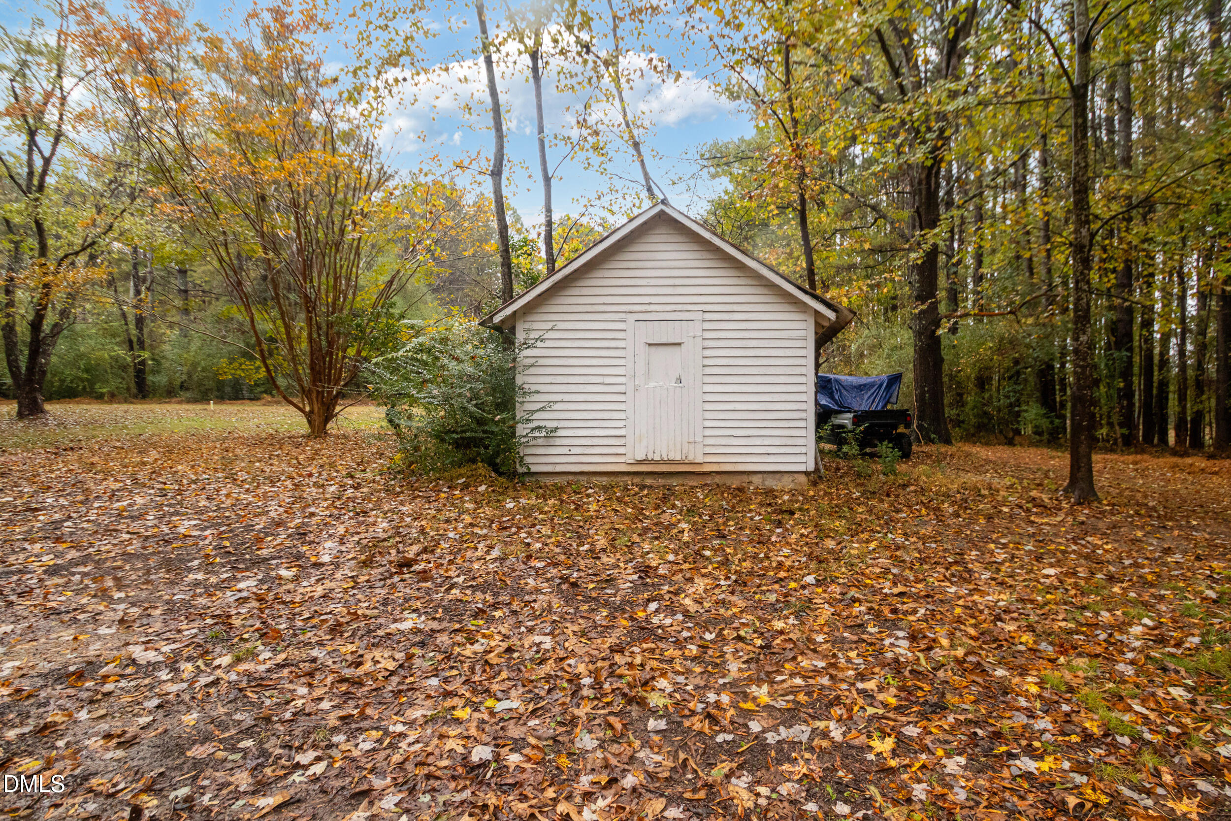 1734 Rocky Ford Road Henderson, NC 27537 - Photo 33 of 44 a backyard of a house with a tree