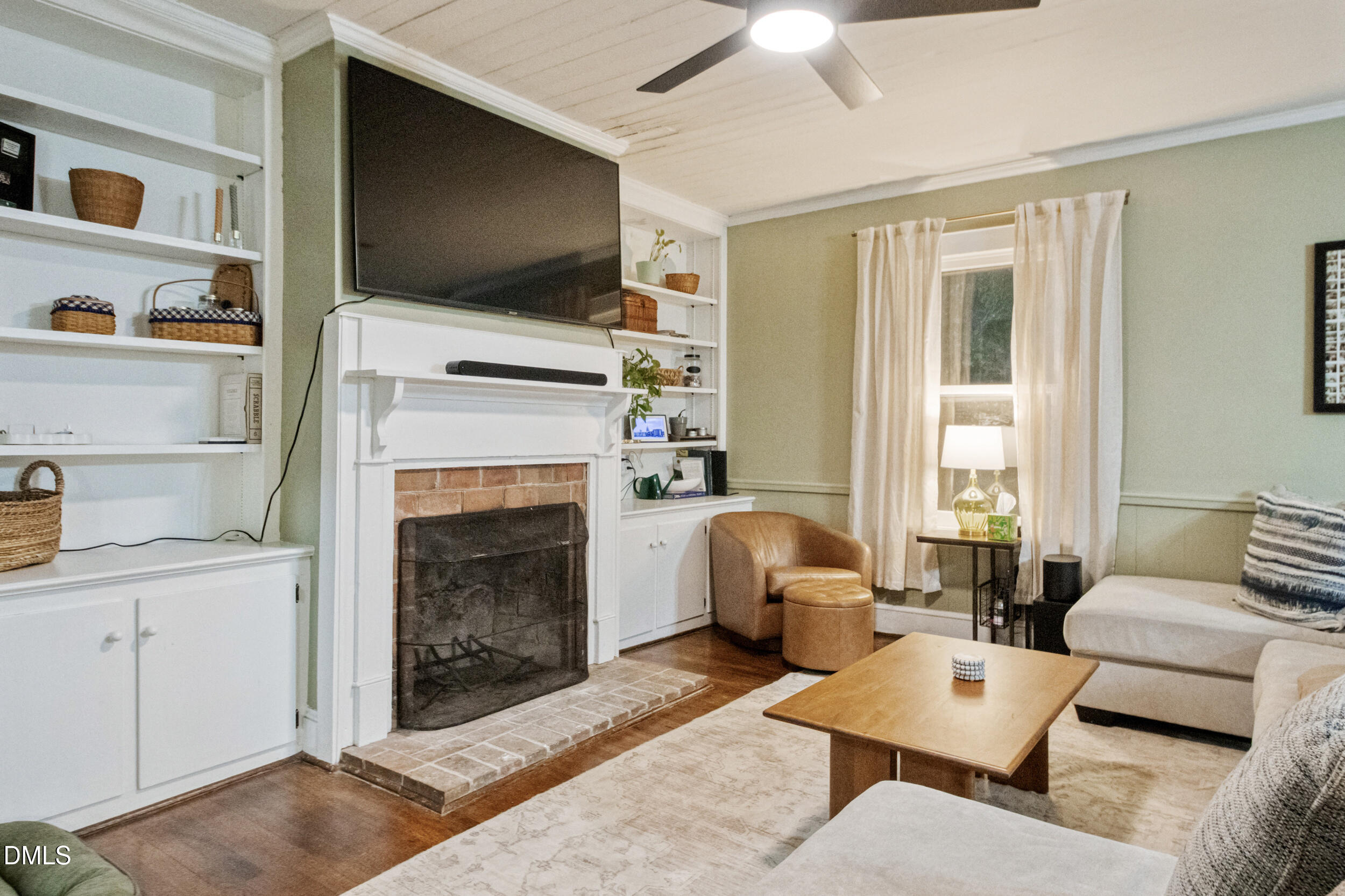 1734 Rocky Ford Road Henderson, NC 27537 - Photo 4 of 44 a living room with furniture a flat screen tv and a fireplace