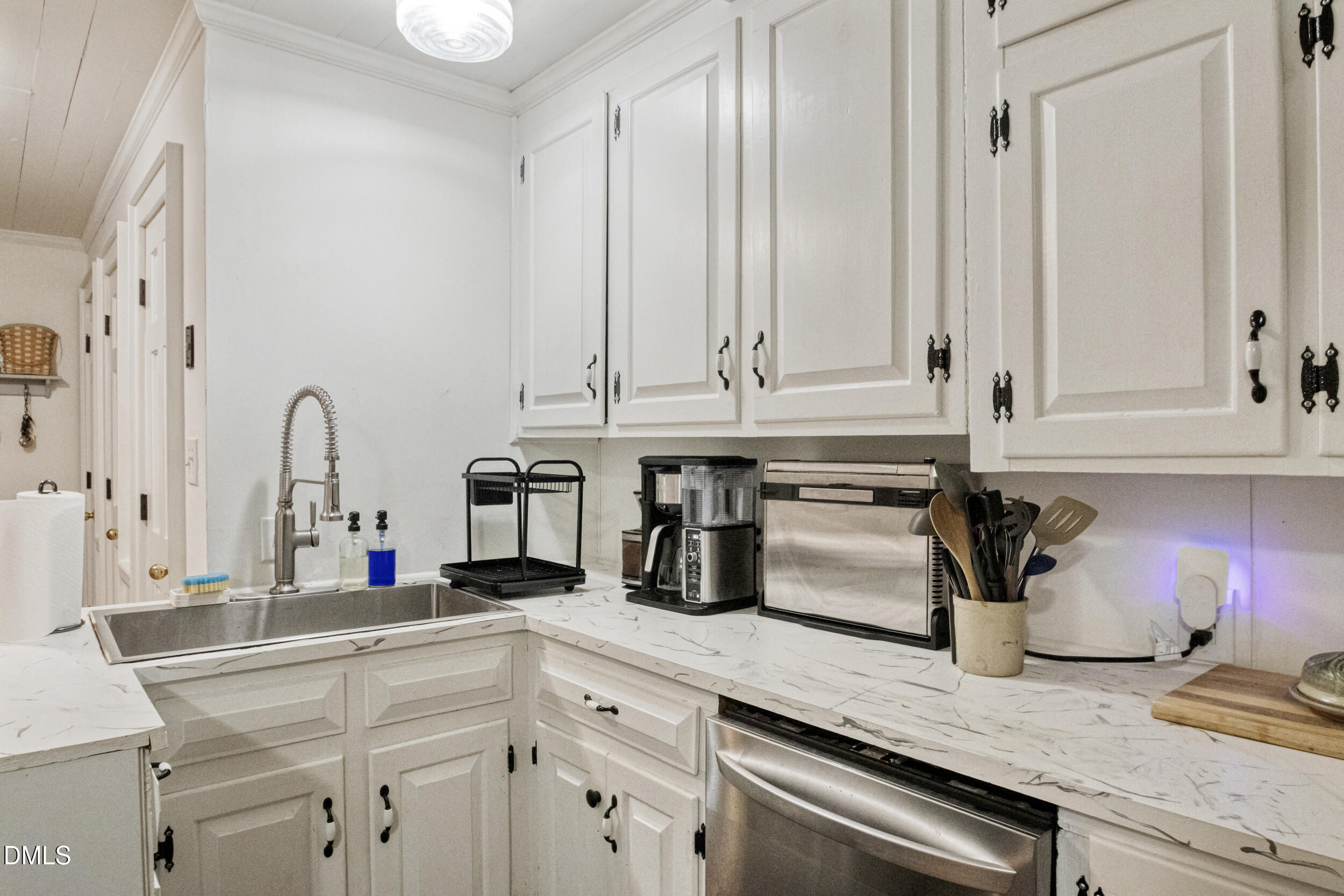 1734 Rocky Ford Road Henderson, NC 27537 - Photo 8 of 44 a kitchen with stainless steel appliances granite countertop white cabinets and a granite counter tops