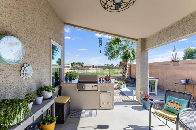 a living room with patio furniture and a potted plant