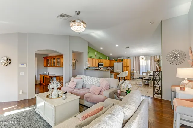 a living room with furniture and a chandelier