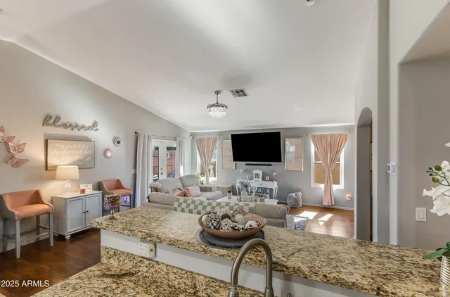 a living room with furniture and a flat screen tv