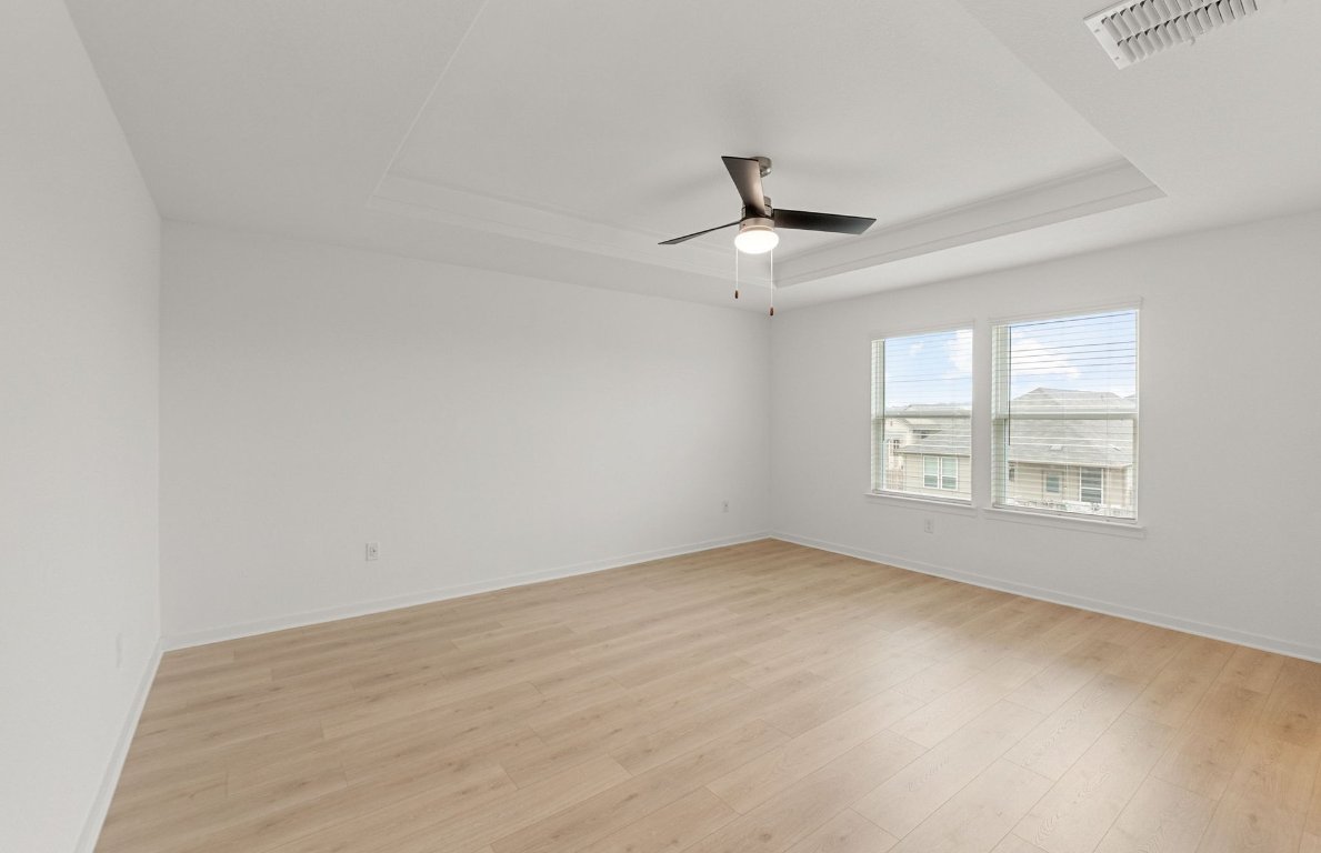 360 Begonia Street Buda, TX 78610 - Photo 12 of 26 an empty room with a window and a ceiling fan