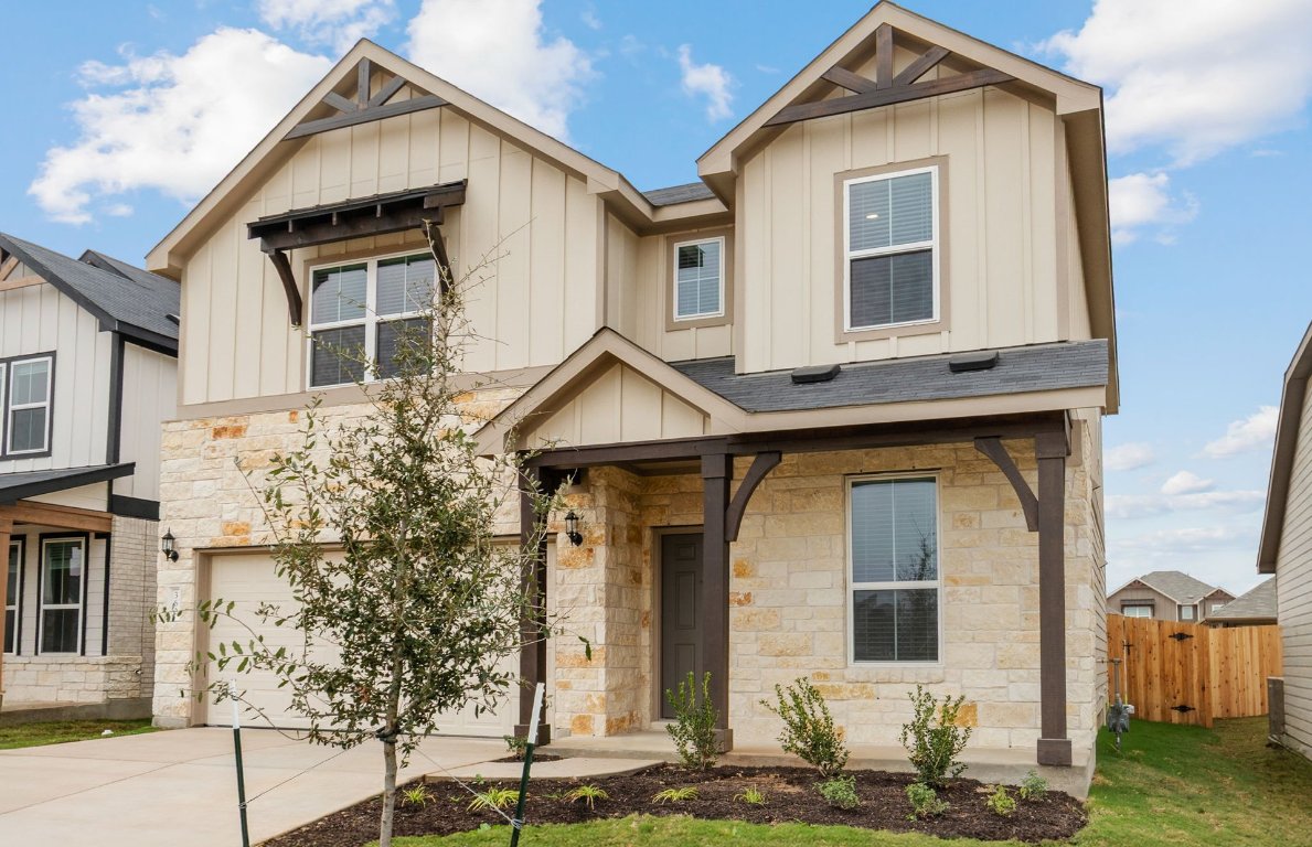 360 Begonia Street Buda, TX 78610 - Photo 2 of 26 a front view of a house with garden