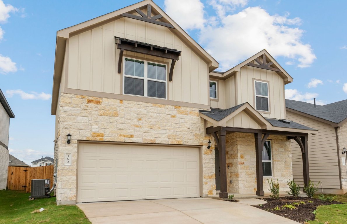 360 Begonia Street Buda, TX 78610 - Photo 3 of 26 a front view of a house with garage