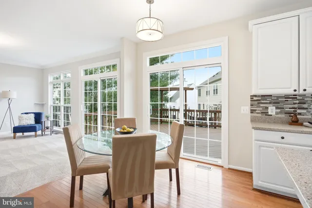 a living room with furniture and a dining table with kitchen view