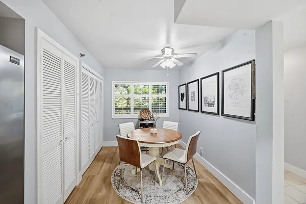 a dining room with furniture a window and wooden floor