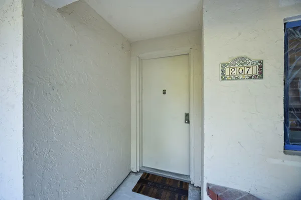 a view of a hallway view with wooden floor and staircase