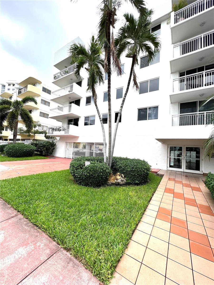 1665 Bay Road, Unit 517 Miami Beach, FL 33139 - Photo 1 of 26 a front view of building with yard